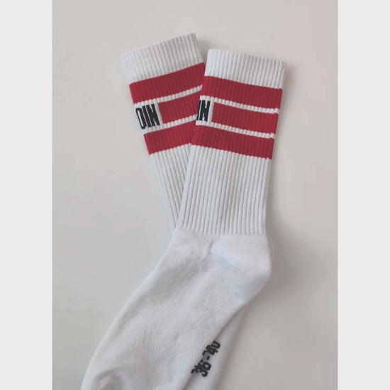 Close up of MOIN unisex recycled tennis socks in white with red stripes, eco-friendly and durable, designed for comfort and performance.